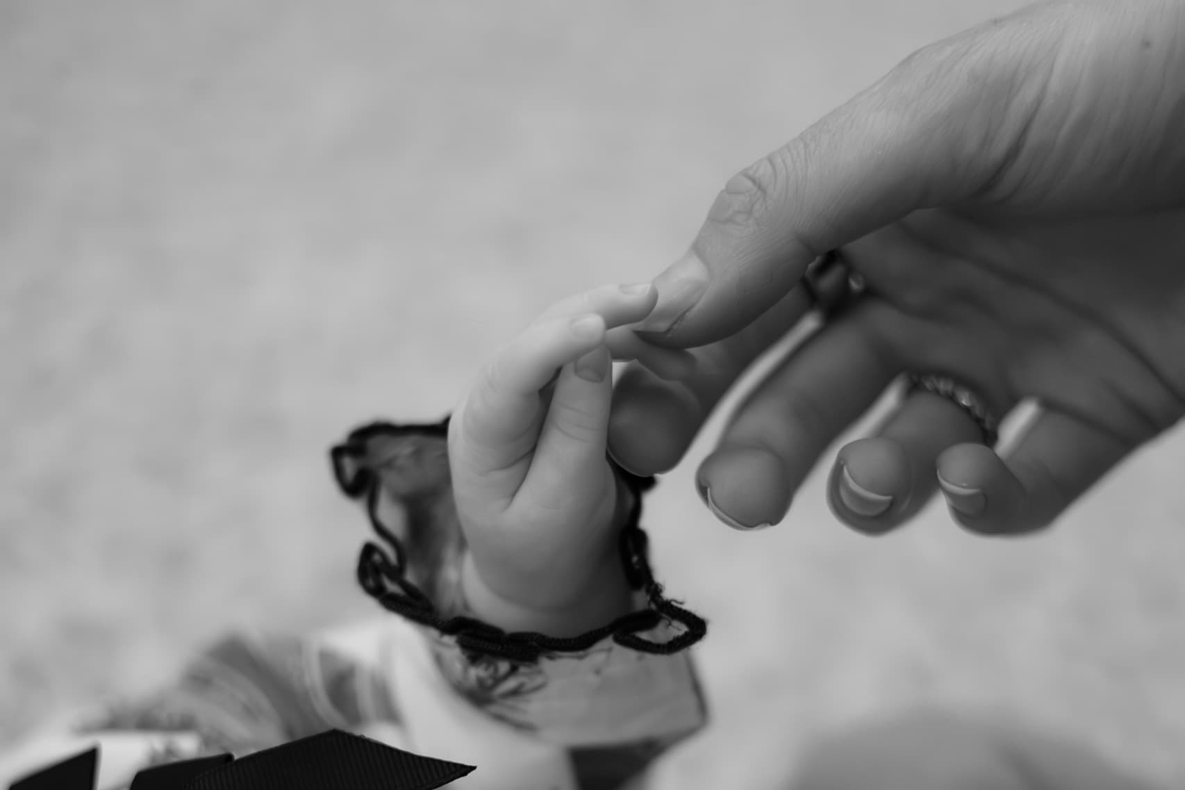 Baby hand reaching for parent