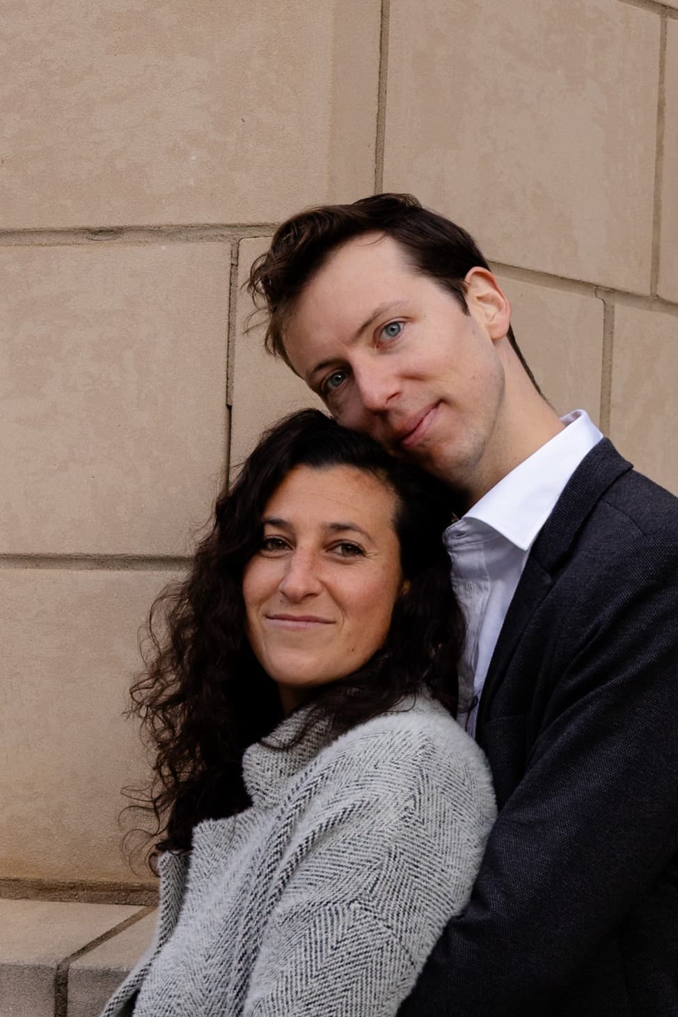 Couple portrait against stone wall